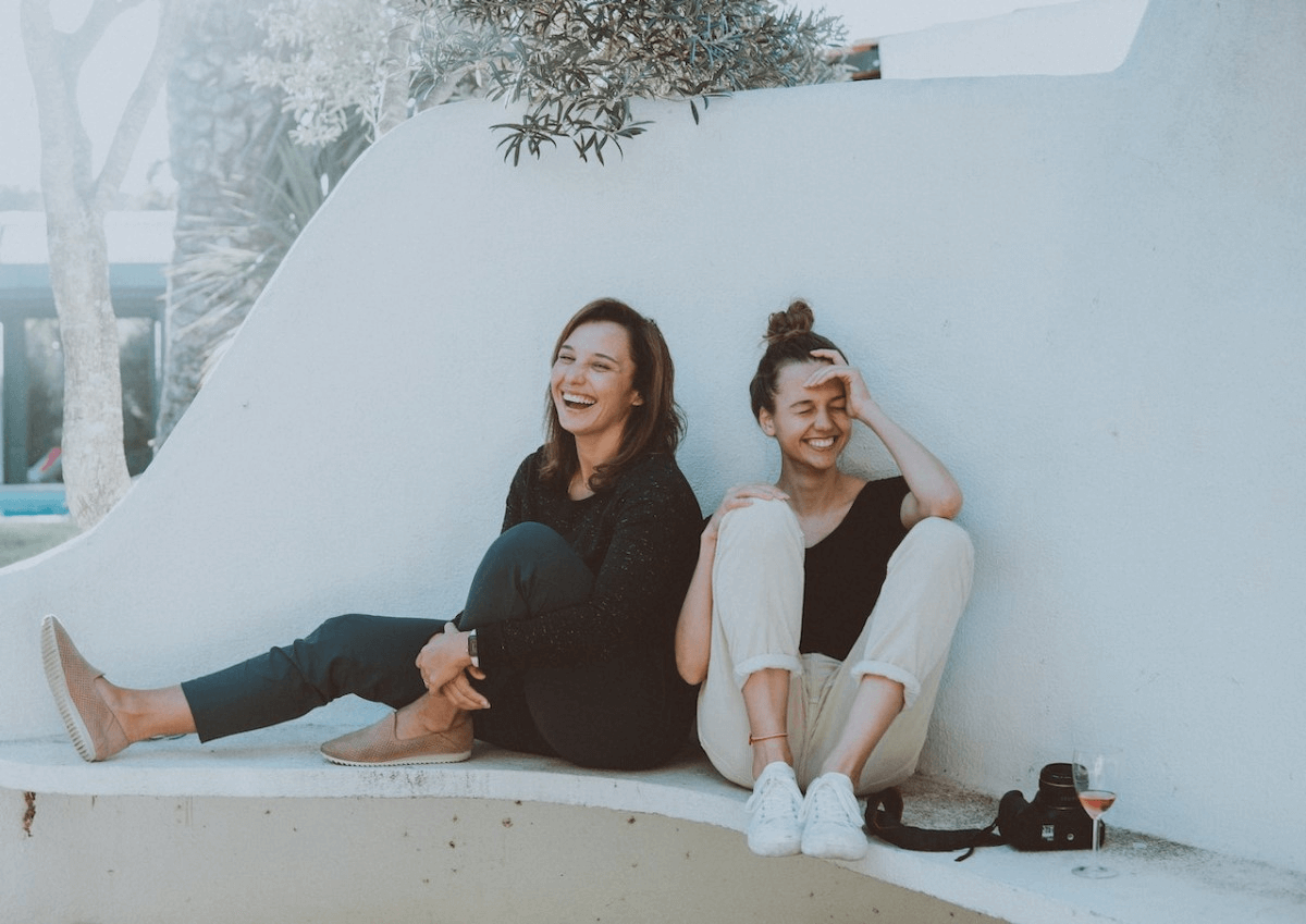 two-women-sitting-and-laughing