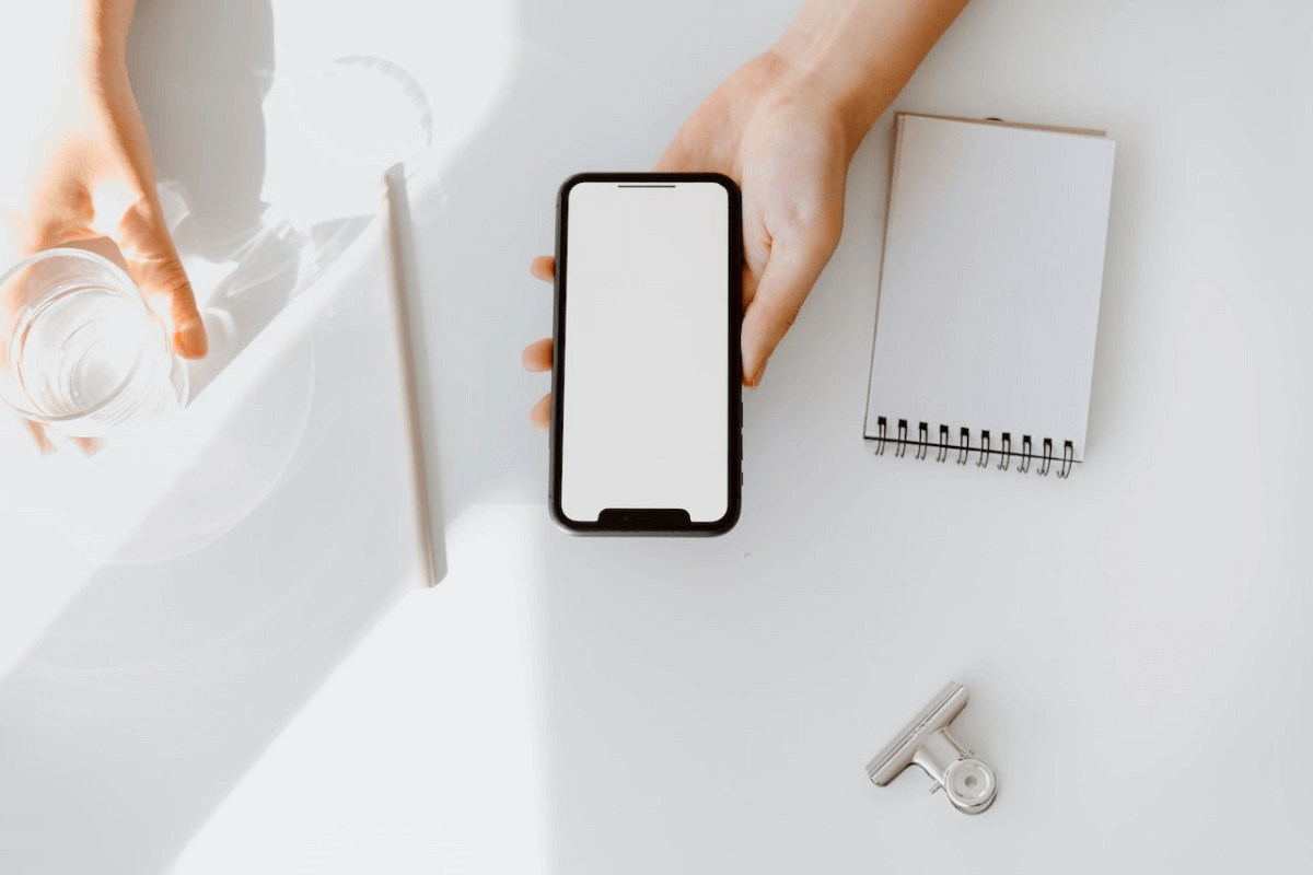 white-stationery-and-smartphone